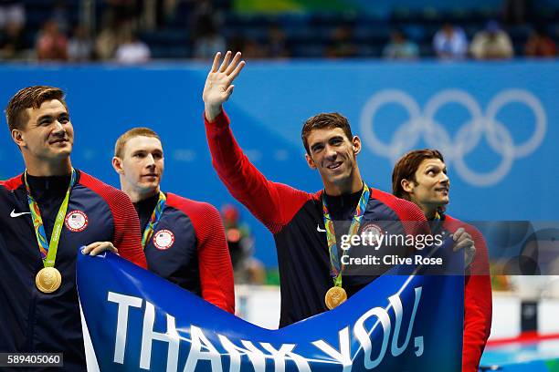 Gold medalist Michael Phelps of the United States waves to the crowd during the medal ceremony for the Men's 4 x 100m Medley Relay Final on Day 8 of...