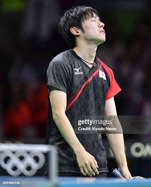 Japan's Koki Niwa reacts after losing a point to Jakub Dyjas of Poland in a table tennis men's team event first-round match at the Rio de Janeiro...