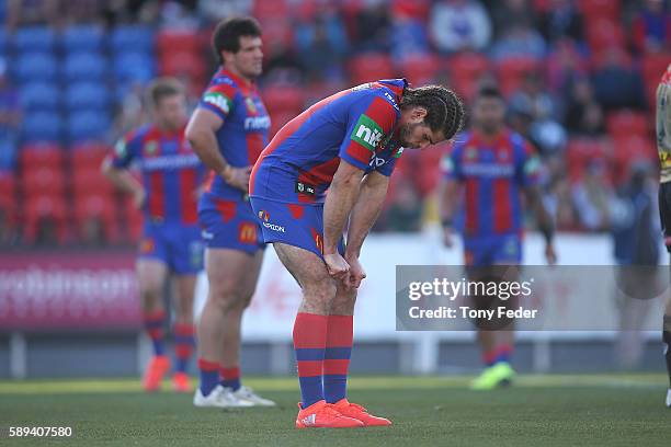 Jake Mamo of the Knights looks dejected as the Panthers celebrate a try during the round 23 NRL match between the Newcastle Knights and the Penrith...