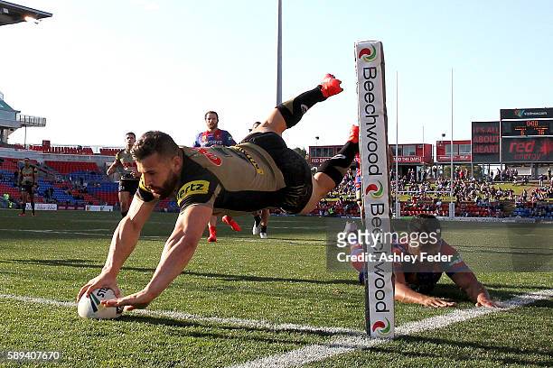 Josh Mansour of the Panthers scores a try during the round 23 NRL match between the Newcastle Knights and the Penrith Panthers at Hunter Stadium on...