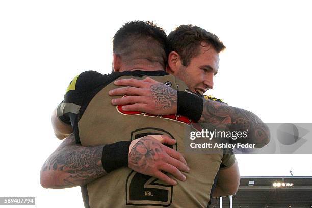 Josh Mansour celebrates his try with Zak Hardaker of the Panthers during the round 23 NRL match between the Newcastle Knights and the Penrith...