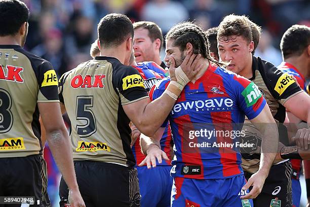 Jake Mamo of the Knights and Dalin Watene-Zelezniak of the Panthers during an altercation during the round 23 NRL match between the Newcastle Knights...