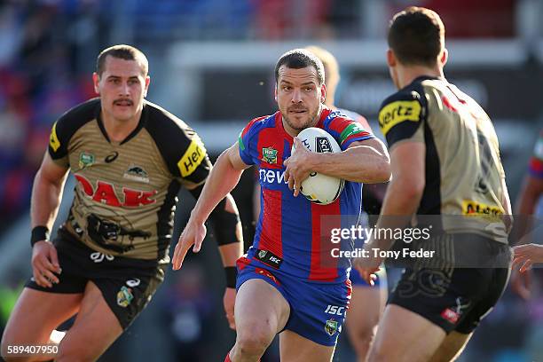 Jarrod Mullen of the Knights runs the ball during the round 23 NRL match between the Newcastle Knights and the Penrith Panthers at Hunter Stadium on...