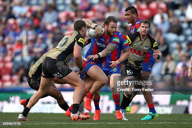 Korbin Sims of the Knights runs the ball during the round 23 NRL match between the Newcastle Knights and the Penrith Panthers at Hunter Stadium on...