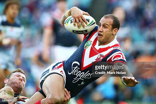 Blake Ferguson looks is taclkled during the round 23 NRL match between the Sydney Roosters and the North Queensland Cowboys at Allianz Stadium on...