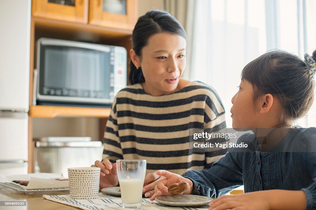 Mother and daughter eating cookies