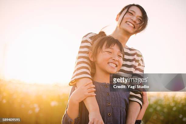mother and daughter are in the cosmos field - happy kids ストックフォトと画像