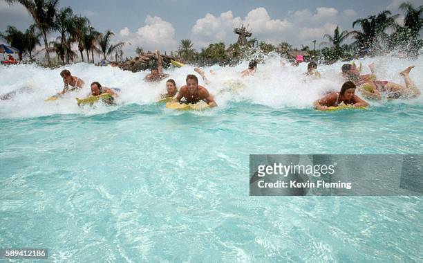 playing in waves at typhoon lagoon - typhoon lagoon stock pictures, royalty-free photos & images