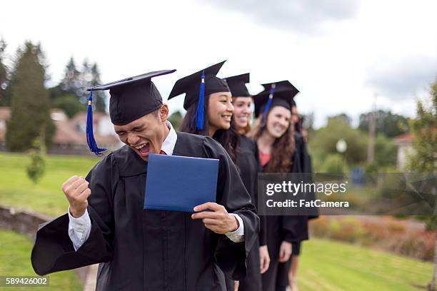 young ethnic male celebrates after receiving his diploma - graduation celebration stock pictures, royalty-free photos & images