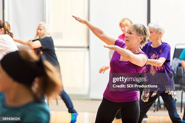 senior women take dance lessons - line dancing stock pictures, royalty-free photos & images