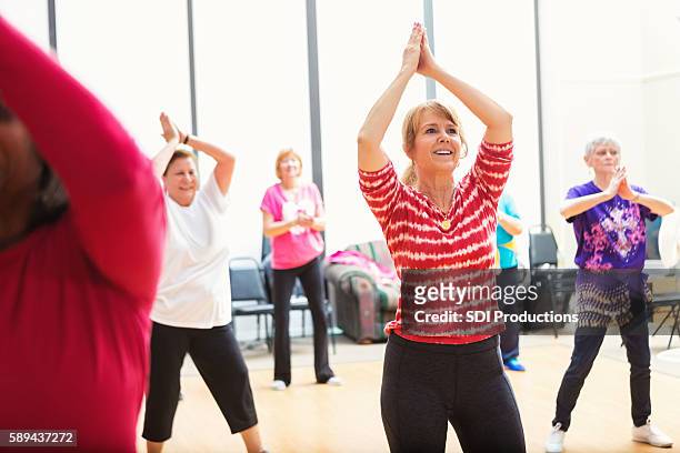 dance class at senior center - line dancing stock pictures, royalty-free photos & images