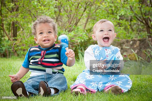 babies enjoying music through play - baby rattle stock pictures, royalty-free photos & images