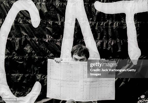 Portrait of English composer and impresario Andrew Lloyd Webber holds up the score of his musicial 'Cats' on the roof of his apartment building, New...