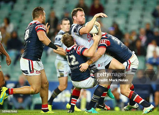 Gavin Cooper of the Cowboys is tackled during the round 23 NRL match between the Sydney Roosters and the North Queensland Cowboys at Allianz Stadium...
