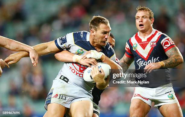 Scott Bolton of the Cowboys is tackled during the round 23 NRL match between the Sydney Roosters and the North Queensland Cowboys at Allianz Stadium...