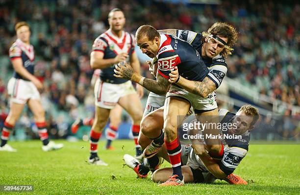 Blake Ferguson of the Roosters runs the ball during the round 23 NRL match between the Sydney Roosters and the North Queensland Cowboys at Allianz...