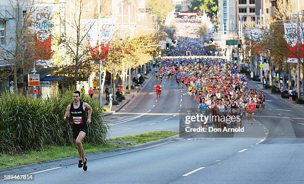 Harry Summers leads the pack up William Street during the start of the 2016 City to Surf on August 14, 2016 in Sydney, Australia.