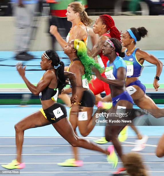 Jamaican sprinter Elaine Thompson leads the other finalists on her way to winning the women's 100-meter gold medal in the athletics competition of...