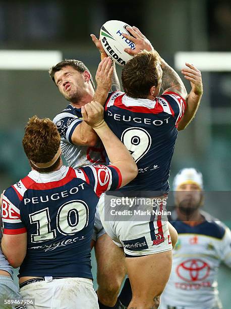 Lachlan Coote of the Cowboys and Jake Friend of the Roosters contest a high ball during the round 23 NRL match between the Sydney Roosters and the...