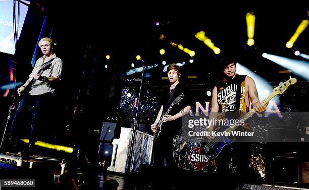 Musicians Michael Clifford, Luke Hemmings and Calum Hood of 5 Seconds of Summer perform at the Pandora Summer Crush at L.A. Live on August 13, 2016...