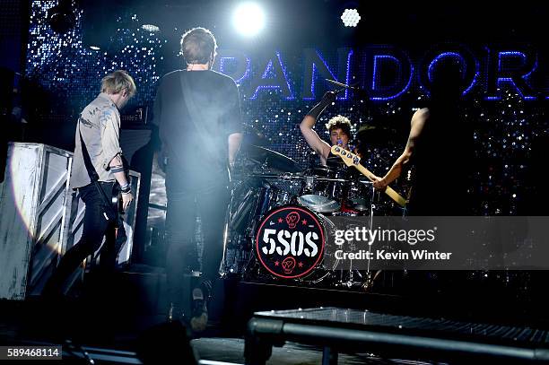 Musicians Michael Clifford, Luke Hemmings, Ashton Irwin and Calum Hood of 5 Seconds of Summer perform at the Pandora Summer Crush at L.A. Live on...