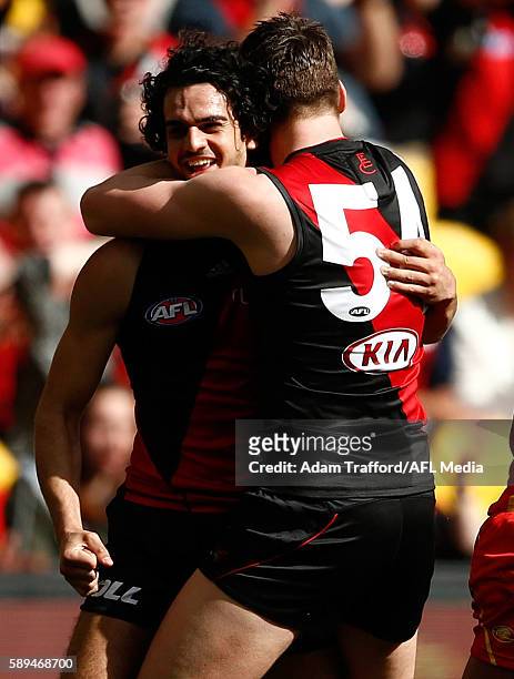 Sam Grimley of the Bombers congratulates Debutante, Jake Long of the Bombers on a piece of play during the 2016 AFL Round 21 match between the...