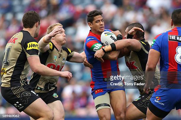 Dane Gagai of the Knights is tackled by the Panthers defence during the round 23 NRL match between the Newcastle Knights and the Penrith Panthers at...