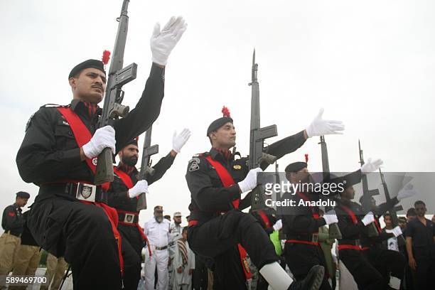 Pakistani police commandos parade during a ceremony marking Pakistan's 69th Independence Day at the founder of Pakistan Muhammad Ali Jinnah's...