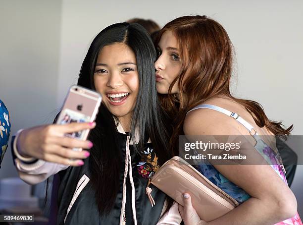 Actresses Ashley Liao and Jane Widdop take a selfie at Amazon and Tiger Beat Magazines premiere of "The Kicks" at StubHub Center on August 13, 2016...