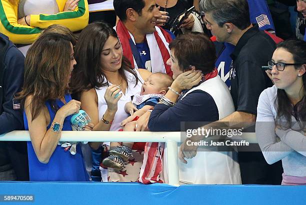 Nicole Johnson, fiancee of Michael Phelps - holding their baby son Boomer Phelps -, and Debbie Phelps, Michael's mother attend the last swimming...