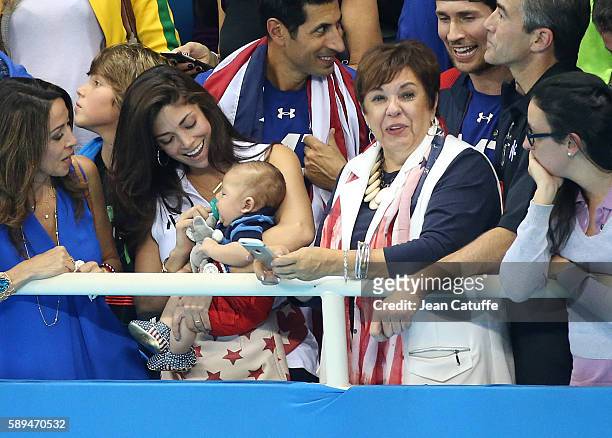 Nicole Johnson, fiancee of Michael Phelps - holding their baby son Boomer Phelps -, and Debbie Phelps, Michael's mother attend the last swimming...