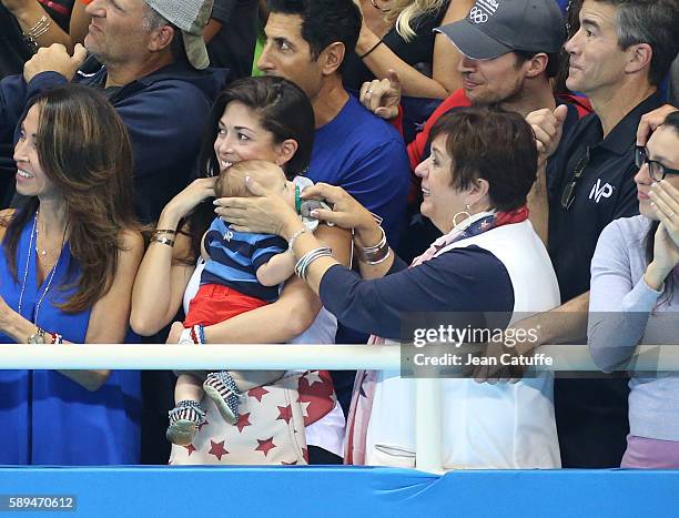 Nicole Johnson, fiancee of Michael Phelps - holding their baby son Boomer Phelps -, and Debbie Phelps, Michael's mother attend the last swimming...