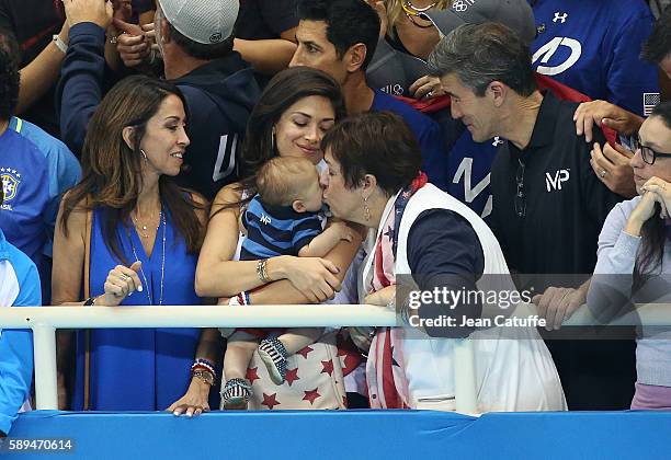 Nicole Johnson, fiancee of Michael Phelps - holding their baby son Boomer Phelps -, and Debbie Phelps, Michael's mother attend the last swimming...