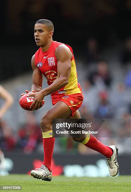 Touk Miller of the Suns kicks the ball during the round 21 AFL match between the Essendon Bombers and the Gold Coast Suns at Etihad Stadium on August...