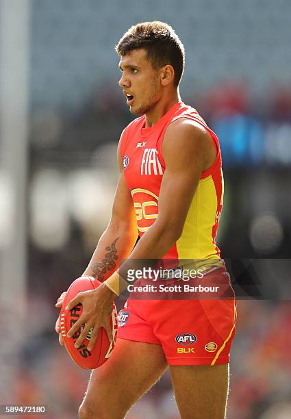 Callum Ah Chee of the Suns kicks the ball during the round 21 AFL match between the Essendon Bombers and the Gold Coast Titans at Etihad Stadium on...