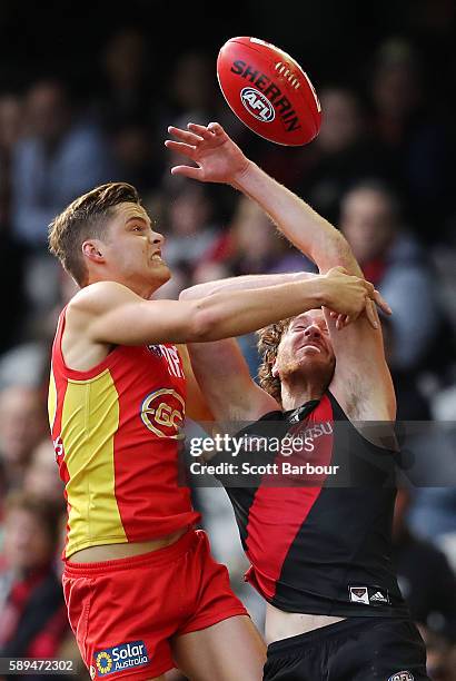 Mitch Brown of the Bombers and Kade Kolodjashnij of the Suns compete for the ball during the round 21 AFL match between the Essendon Bombers and the...