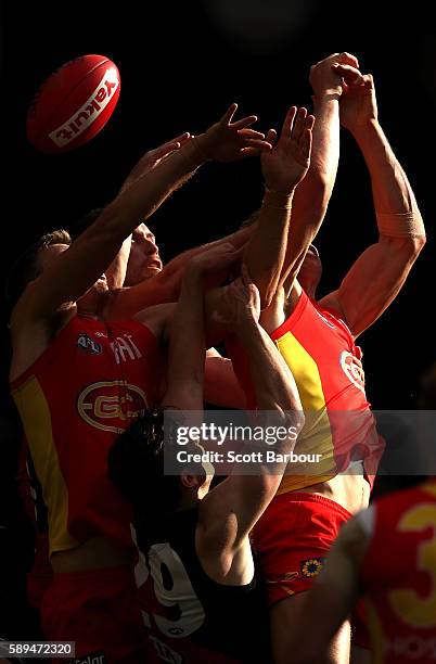 Matthew Leuenberger of the Bombers and Tom Lynch of the Suns compete for the ball during the round 21 AFL match between the Essendon Bombers and the...