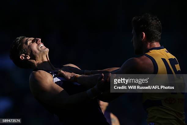 Matthew Pavlich of the Dockers is grabbed by Kyle Hartigan of the Crows during the round 21 AFL match between the Fremantle Dockers and the Adelaide...