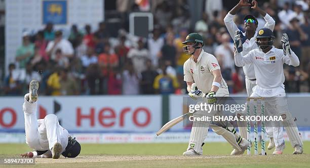 Sri Lanka cricketer Kaushal Silva drops a possible catch off Australian cricket captain Steven Smith as Sri Lankan wicketkeeper Kusal Perera and...