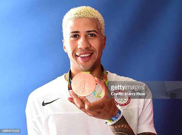 Fencer, Miles Chamley-Watson of the United States poses for a photo with his bronze medal on the Today show set on Copacabana Beach on August 13,...