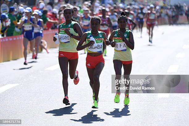 Tirfi Tsegaye of Ethiopia, Mare Dibaba of Ethiopia and Tigist Tufa of Ethiopia run during the Women's Marathon on Day 9 of the Rio 2016 Olympic Games...