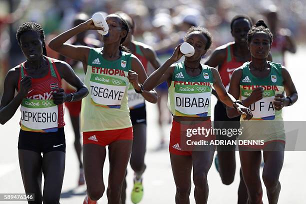 Kenya's Visiline Jepkesho, Ethiopia's Tirfi Tsegaye, Ethiopia's Mare Dibaba and Ethiopia's Tigist Tufa compete in the Women's Marathon during the...