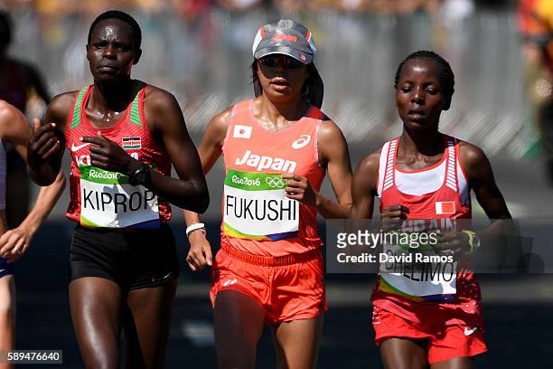 Helah Jelagat Kiprop of Kenya, Kayoko Fukushi of Japan and Rose Chelimo of Bahrain compete during the Women's Marathon on Day 9 of the Rio 2016...