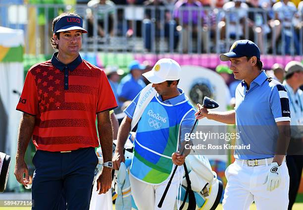 Bubba Watson of the United States and Emiliano Grillo of Argentina walk from the first tee during the final round of golf on Day 9 of the Rio 2016...