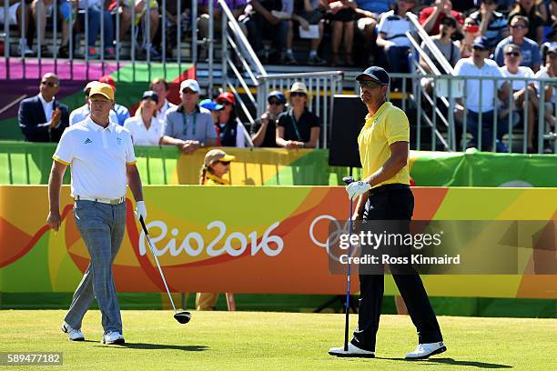 Henrik Stenson of Sweden and Marcus Fraser of Australia look on from the fist tee during the final round of golf on Day 9 of the Rio 2016 Olympic...
