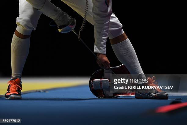 Ukraine's Dmytro Karyuchenko bends his sword during the mens team epee quarter-final bout between Russia and Ukraine as part of the fencing event of...