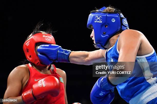 Kazakhstan's Dariga Shakimova is punched by Canada's Ariane Fortin-Brochu during the Women's Middle match at the Rio 2016 Olympic Games at the...