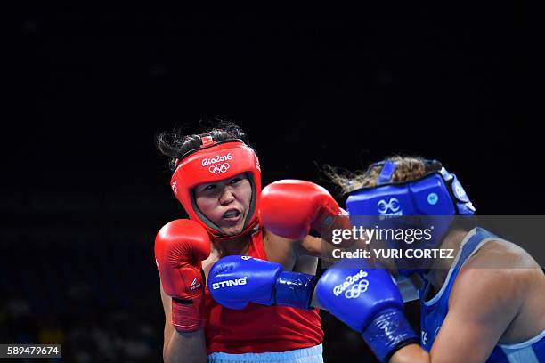 Kazakhstan's Dariga Shakimova fights Canada's Ariane Fortin-Brochu during the Women's Middle match at the Rio 2016 Olympic Games at the Riocentro -...