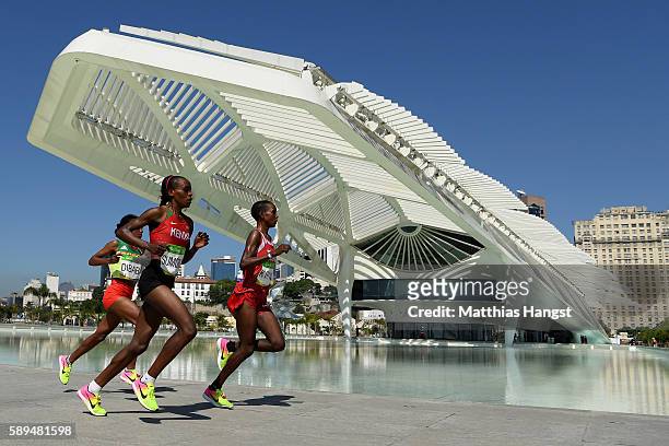 Jemima Jelagat Sumgong of Kenya competes against Mare Dibaba of Ethiopia and Eunice Jepkirui Kirwa of Bahrain during the Women's Marathon on Day 9 of...