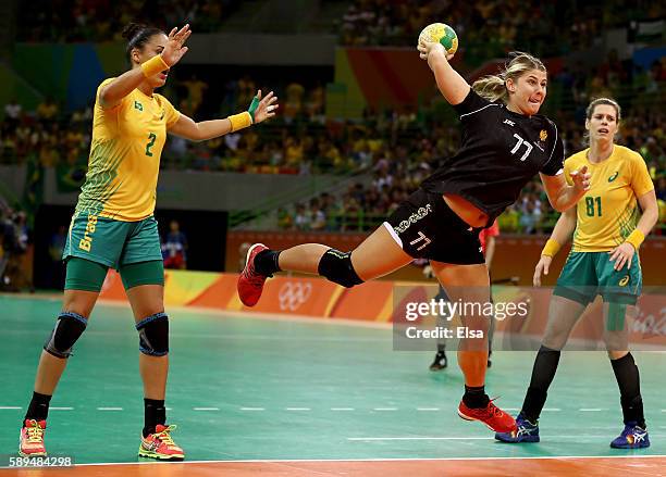 Majda Mehmedovic of Montenegro takes a shot as Fabiana Diniz and Deonise Fachinello of Brazil defend on Day 9 of the Rio 2016 Olympic Games at the...